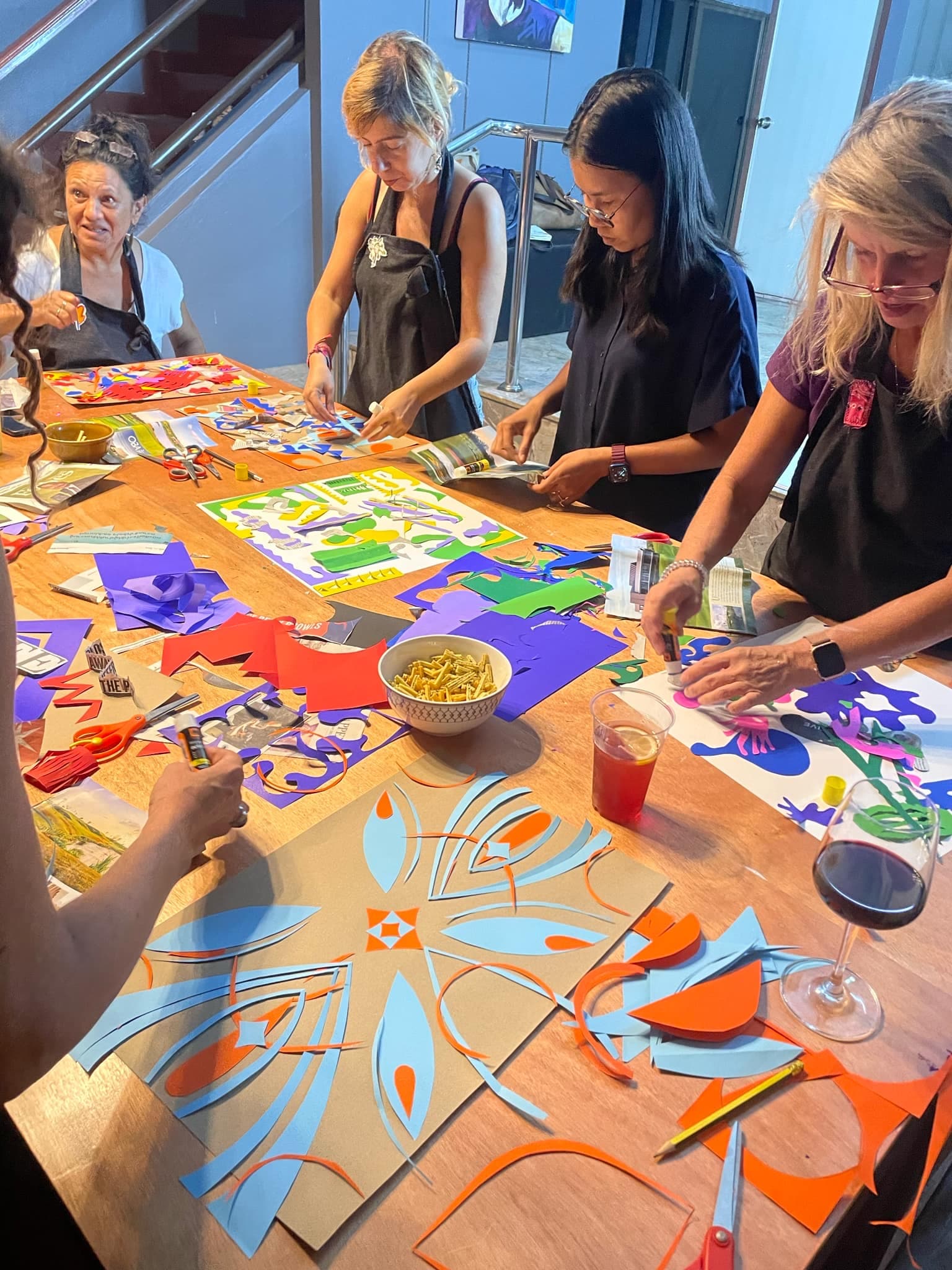 Adults doing colourful paper cutting