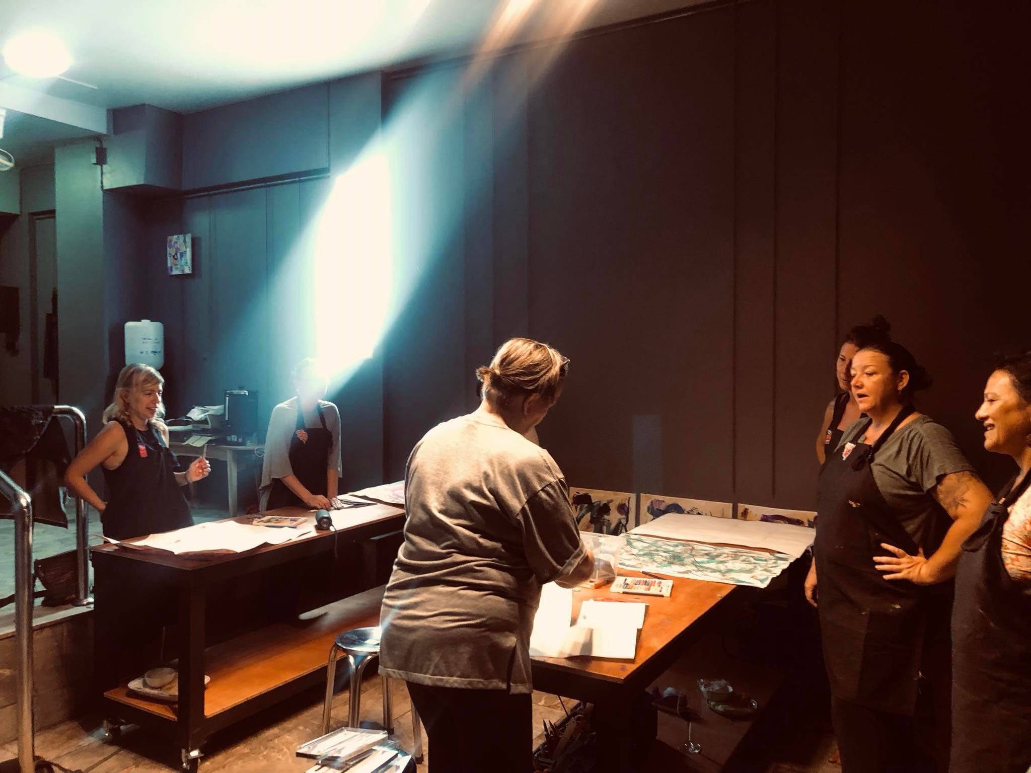 Adults in studio with dramatic lighting