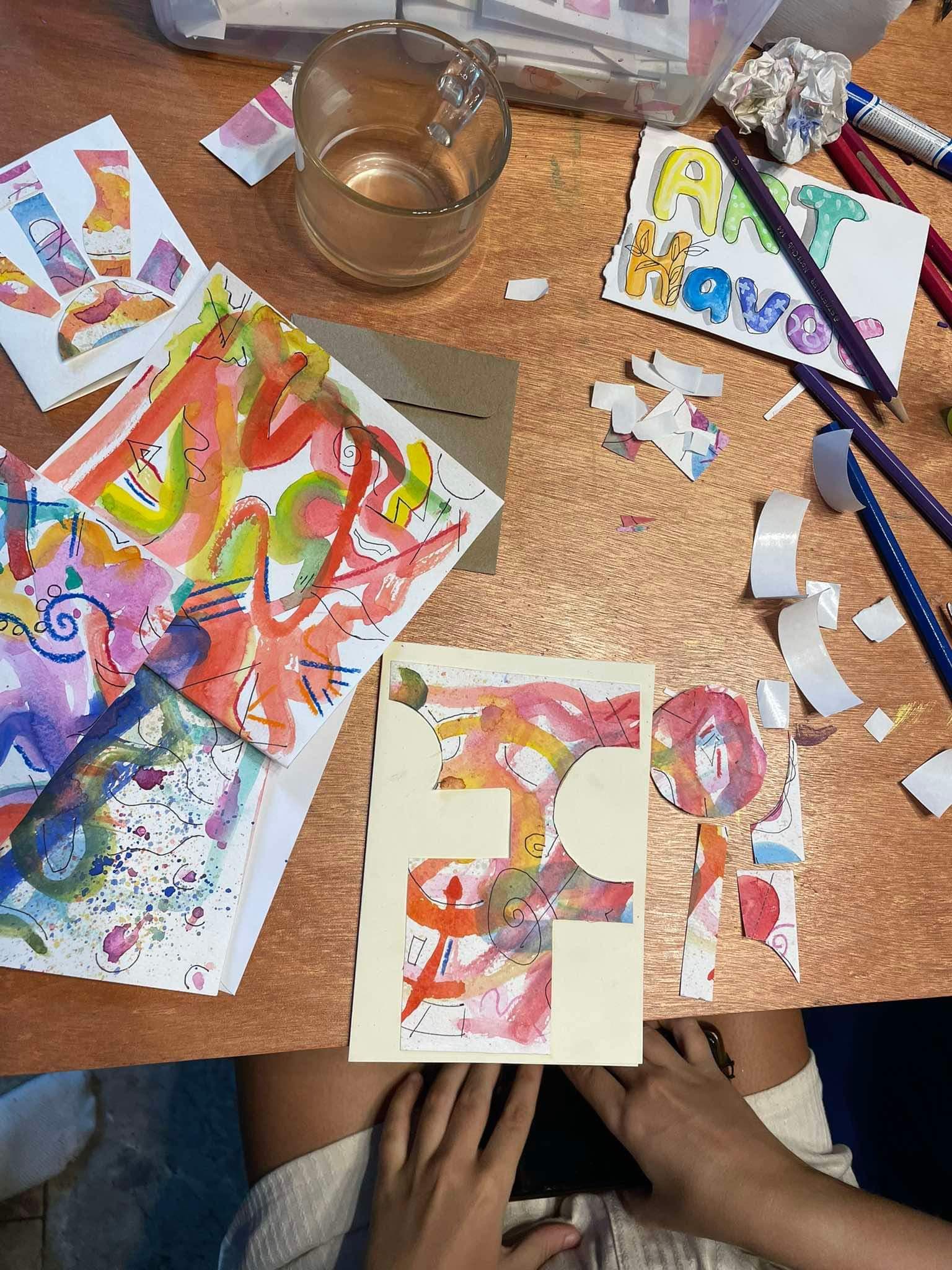 Overhead shot of colourful kids artwork on table