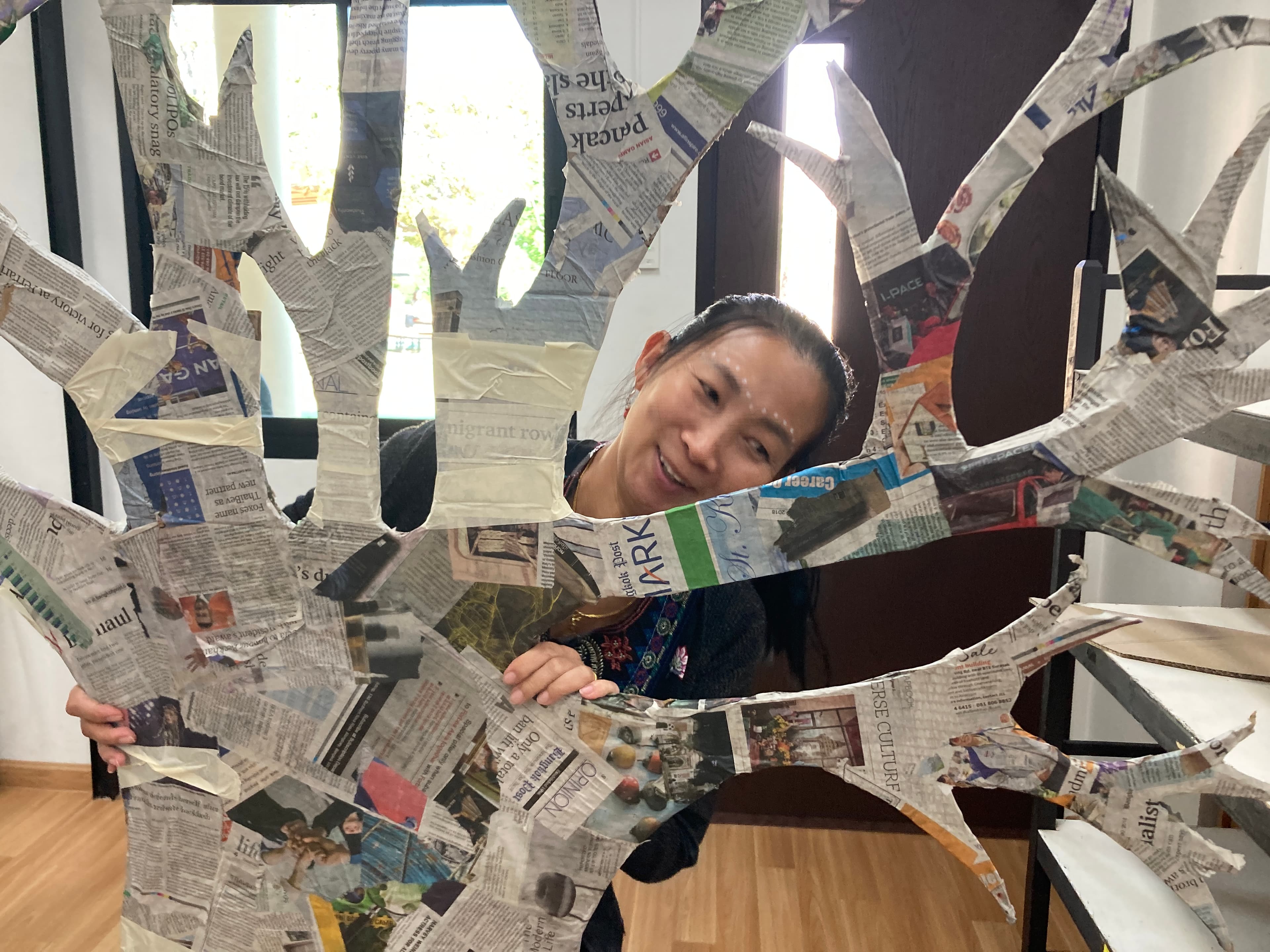 Woman with newspaper sun sculpture