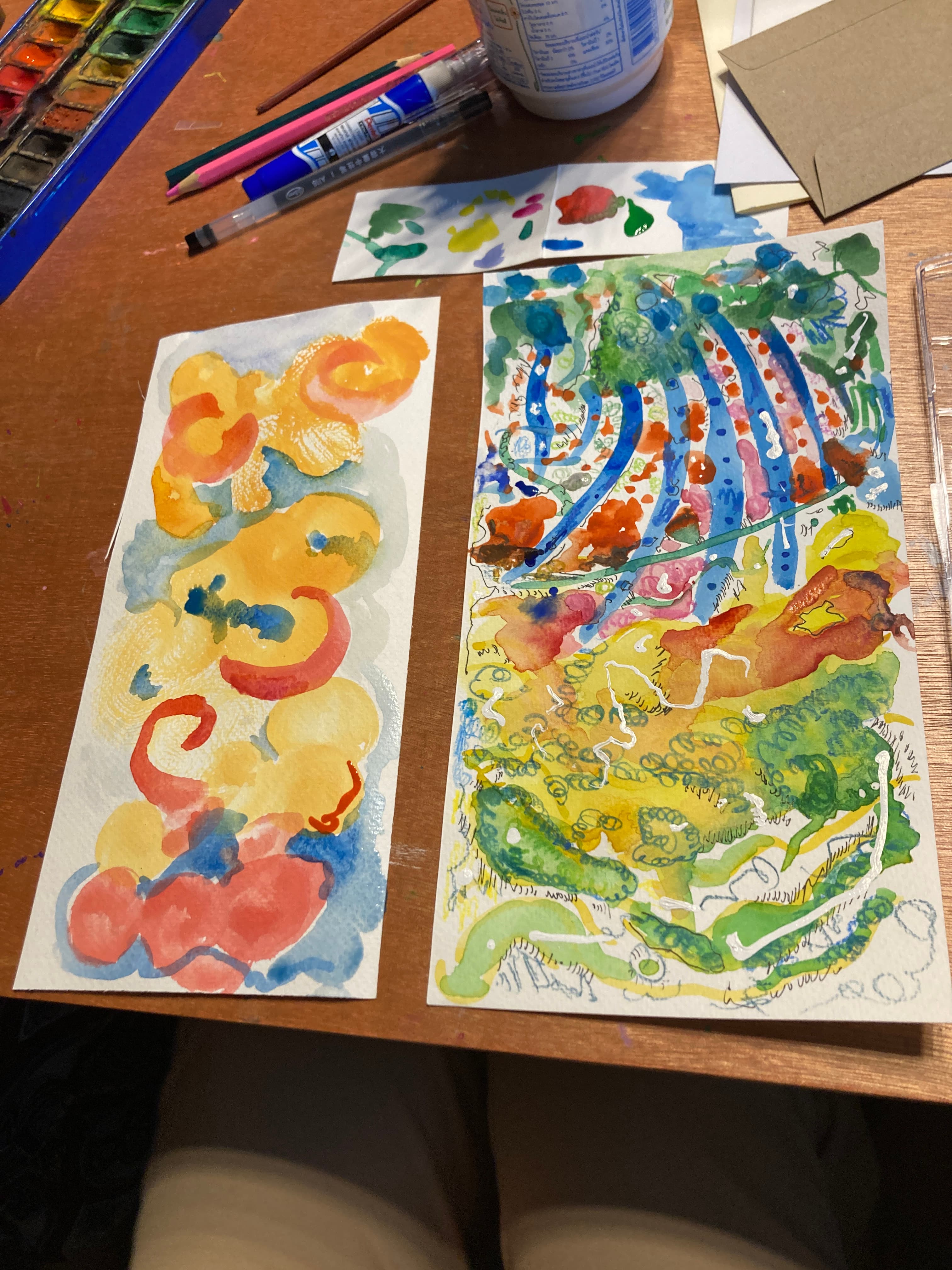 Two watercolour paintings on desk