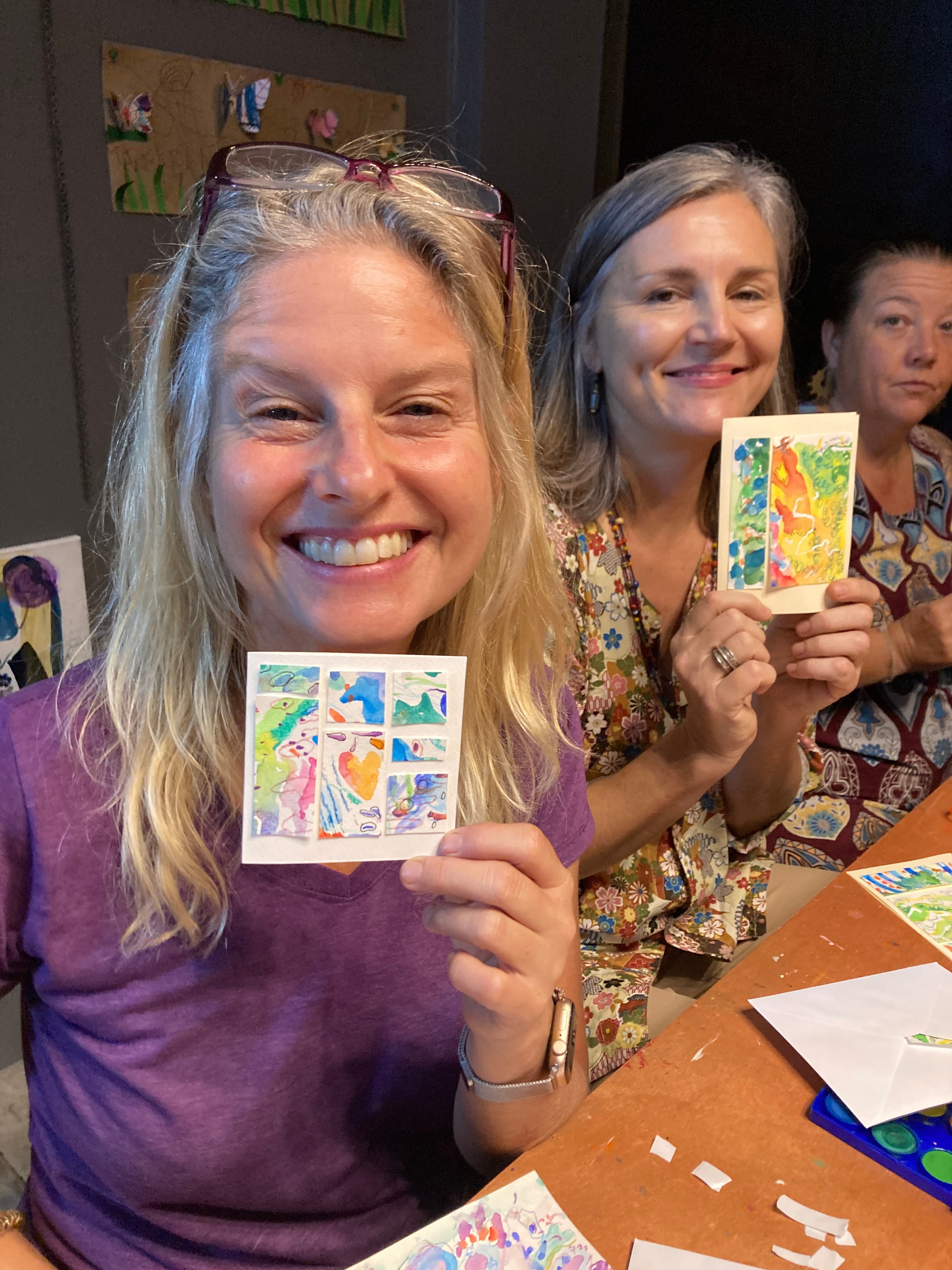 Women showing small watercolour cards